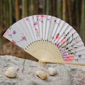 Traditional handmade silk folding fan with bamboo frame and elegant floral pattern