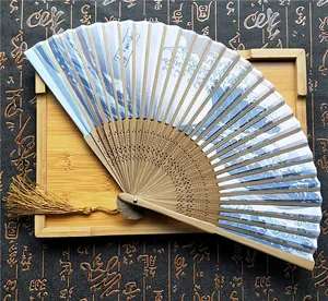 Primer plano del abanico plegable de bambú con el diseño de la gran ola de Kanagawa.