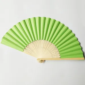 Vibrant green paper folding fan with carved bamboo ribs for wedding decor and DIY art
