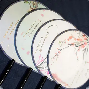 Detailed view of traditional Chinese round fans with floral prints and calligraphy
