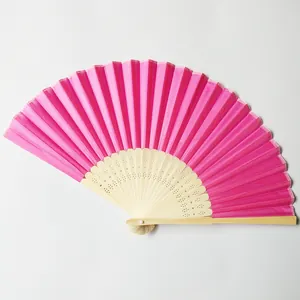 Macro detail of a vibrant rose red silk folding fan featuring hollow bamboo ribs.