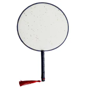 Close-up of traditional Chinese round fan with gold fleck texture and red tassel