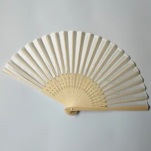 Detailed view of white silk folding fan with intricate bamboo carvings
