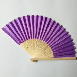 Detailed macro view showing the purple silk fabric and bamboo ribs of this folding hand fan