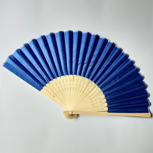 Close-up view of a classic dark blue silk folding fan with hollowed bamboo frame ribs