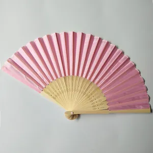 Detailed view of an elegant pink silk folding fan featuring decorative bamboo ribs
