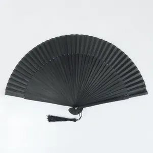 Elegant all-black bamboo folding hand fan featuring a matching decorative silk tassel detail.