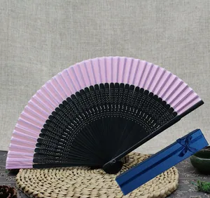 Detailed view of pink bamboo folding fan and elegant blue gift box packaging