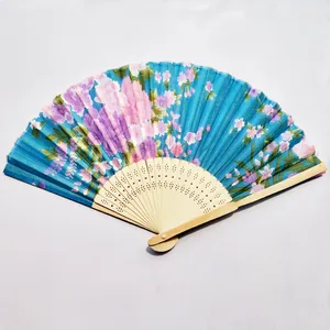 Detailed close-up showing the vibrant blue floral print and carved natural bamboo frame