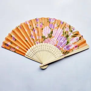 Close-up detail of a traditional Japanese floral print fabric folding fan with bamboo ribs