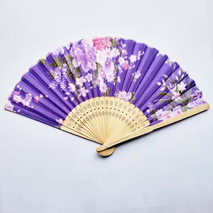 Detailed view of a purple Japanese folding fan with elegant floral print and bamboo ribs