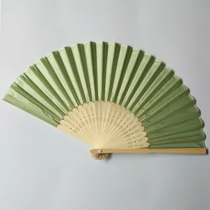 Elegant light green silk folding fan with intricate hollowed bamboo ribs detail