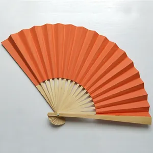 Detailed view of a 9-inch orange blank folding fan with natural bamboo ribs