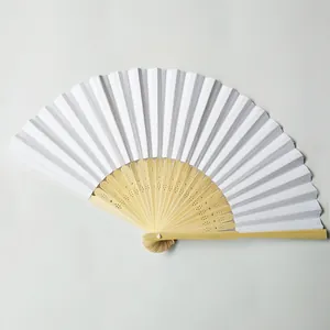 Detailed macro view of a white blank DIY paper fan with natural bamboo ribs for wedding.