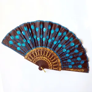 Detailed view of a sequined folding fan with a blue peacock feather embroidery pattern.
