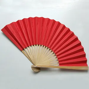 Detailed macro view of a 9-inch vibrant red folding fan featuring natural bamboo ribs