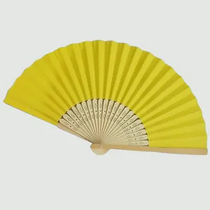 Vibrant yellow folding paper fan with decorative bamboo ribs for DIY wedding crafts
