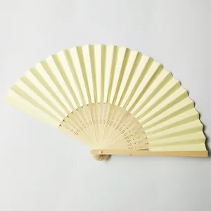Close-up of beige paper wedding fan with carved bamboo ribs for DIY crafts.
