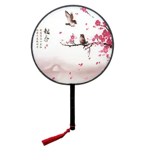 Detailed view of traditional Chinese silk round fan featuring plum blossom ink painting