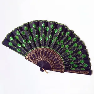 Elegant Spanish folding fan featuring green peacock sequin embroidery on dark purple fabric