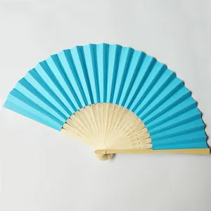 Detailed close-up showing the vibrant blue paper folding fan with decorative carved bamboo ribs.
