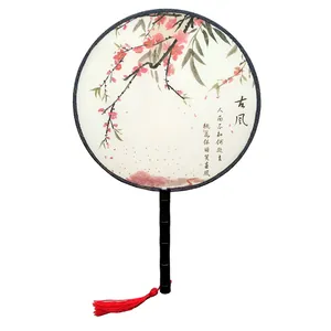 Detail of a Chinese round fan with plum blossom painting and red tassel
