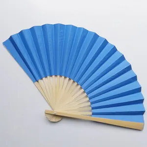 Close-up of a blue blank folding fan showing paper texture and natural wooden ribs
