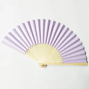 Detailed top view of a purple folding paper fan with natural bamboo ribs for DIY crafts.