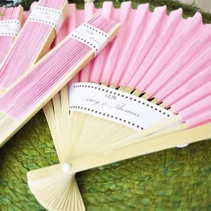 Elegant 9-inch pink paper folding fans with bamboo ribs, perfect for wedding favors.
