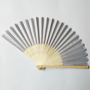 Elegant silver silk folding fan featuring natural bamboo ribs with decorative hollow patterns