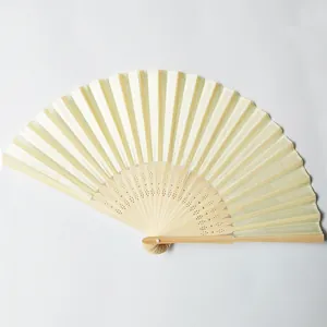 Close-up view of a traditional white silk folding fan featuring hollow-carved bamboo ribs