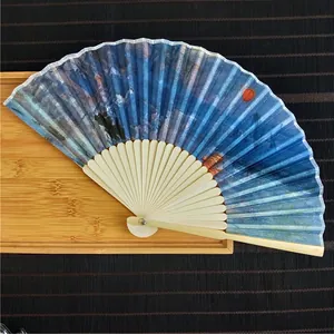 Detailed view of elegant bamboo folding fan featuring Impression Sunrise oil painting print