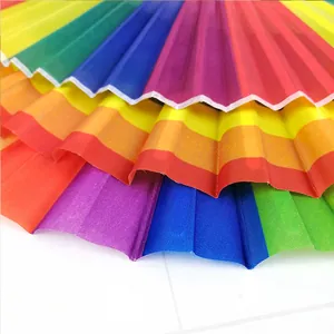 Close-up of vibrant rainbow colored fabric and pleats on a folding wedding fan