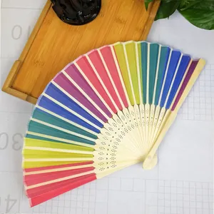 Detailed macro view of a vibrant rainbow folding fan featuring natural bamboo ribs.