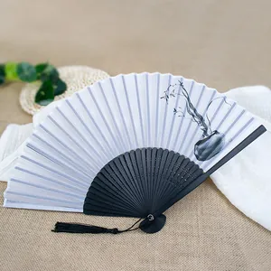 Traditional 6-inch Chinese folding fan featuring ink wash painting and elegant black tassel