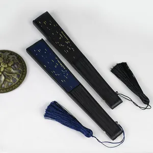 Close-up detail of Chinese folding fans with starry sky pattern and elegant tassels