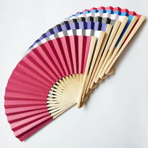 Detail view of colorful 23cm folding paper fans with bamboo ribs in various shades