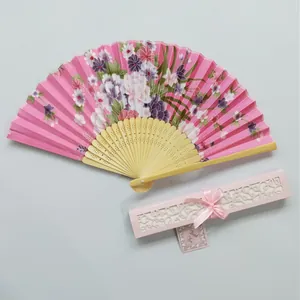 Elegant Japanese floral folding fan with pink hollow gift box for wedding favors.