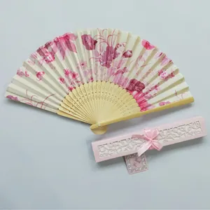 Elegant Japanese folding fan with pink cherry blossom pattern and ornate hollow gift box