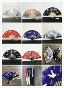 Collection of traditional Chinese folding fans with crane patterns and bamboo ribs.