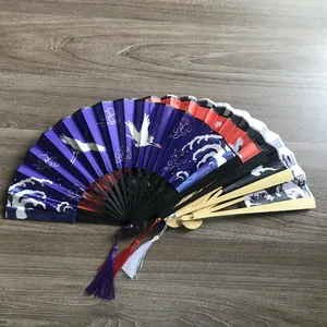 Detailed view of Chinese style folding fans featuring crane patterns and bamboo ribs.