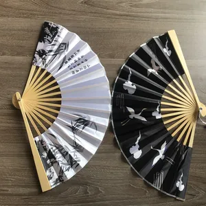 Detailed view of 23cm traditional Chinese bamboo and satin folding fans with crane patterns