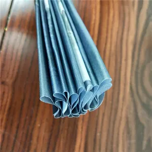 Close-up view of the fine woven fabric texture and folds of a Kung Fu folding fan.