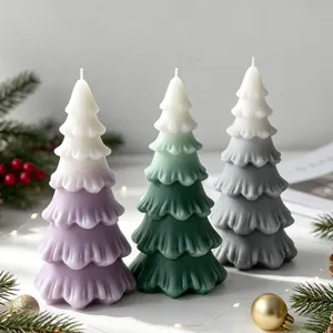 Beautiful set of gradient Christmas tree scented candles in purple, green and grey colors.