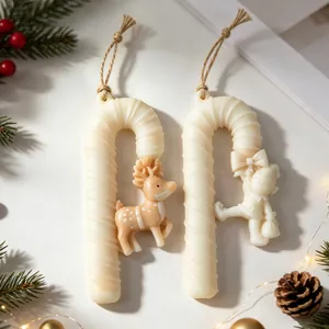 Detailed close-up of festive Christmas candy cane scented candle pendants with cute reindeer
