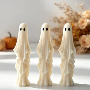 Detailed close-up of handmade ghost candles for minimalist Halloween home decor aesthetic