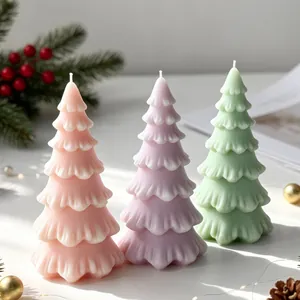 Pastel colored Christmas tree shaped candles featuring pink purple and green hues.