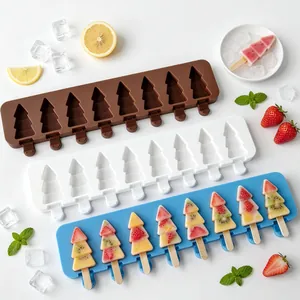 Top-down view of Christmas tree shaped silicone popsicle molds with colorful fruit pops