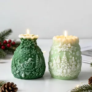 Detailed festive Christmas gift bag scented candles featuring Santa and tree reliefs