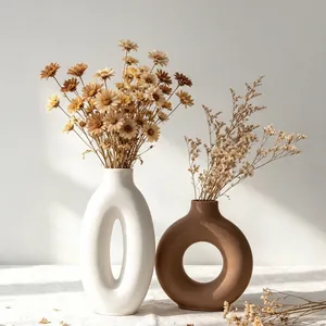 Modern donut and oval plaster vases with dried flowers made from DIY molds